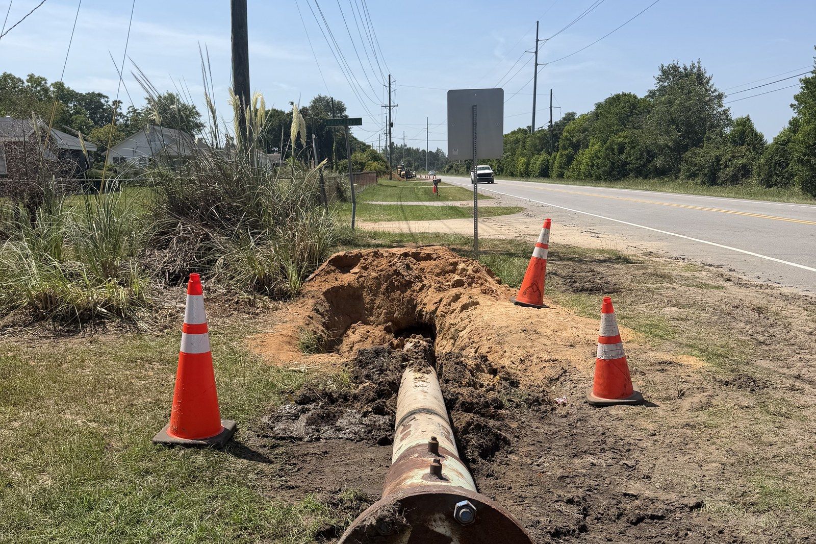 Steel casing staged beside a road crossing